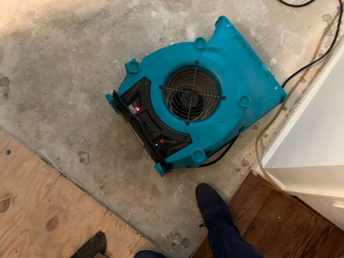 Air mover drying subfloor during Leak Detection & Repair in Yarmouth
